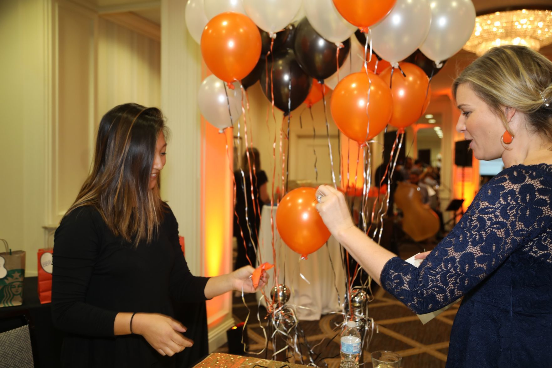 Annette Hall pops balloon